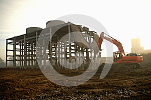 Dismantling ruin by digger