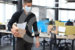 Dismissal employee in an epidemic coronavirus. Dismissed worker going from the office with his office supplies