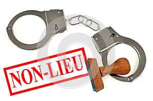 Dismissal written in french on white background next to an ink pad and handcuffs