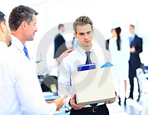 Dismissed businessman carrying box