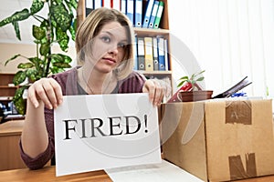 Dismissed worker with sheet of paper with fired word