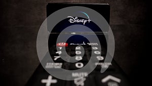 Disney Plus Streaming - Flight over TV Remote control - CITY OF FRANKFURT, GERMANY - MARCH 29, 2021