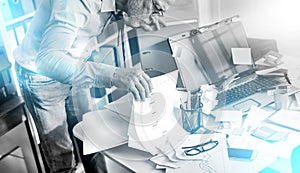 Disorganized businessman looking for documents, light effect