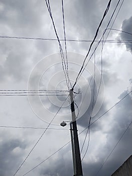 Disorganized telephone pole wires under the sky