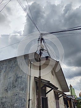 Disorganized telephone pole wires under the sky