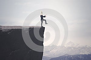 Disoriented businessman walks on the cliff