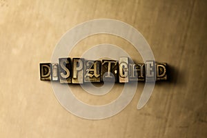 DISPATCHED - close-up of grungy vintage typeset word on metal backdrop photo