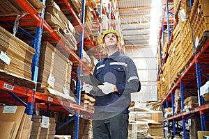 Dispatcher in uniform making inventory in storehouse. supply chain concept