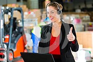 Dispatcher using headset at warehouse of forwarding photo