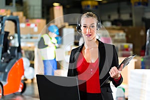Dispatcher using headset at warehouse of forwarding photo