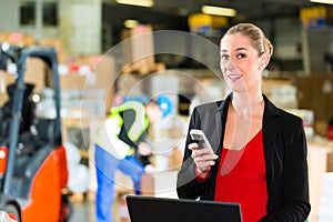 Dispatcher using phone at warehouse of forwarding