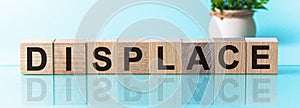 DISPLACE word written on wood block, blu background