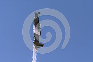 The airplane acrobatico flies in vertical form. photo