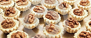 Display of assorted gluten free cupcakes with walnuts  sitting on display table