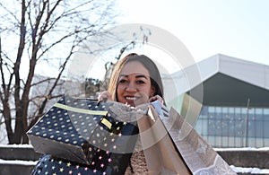 A display of a beautiful female face with shopping bags.