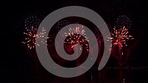 A display of beautiful fireworks at night near the river