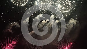 A display of beautiful fireworks at night near the river