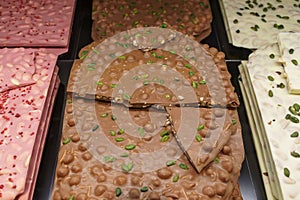 A display of differently colored chocolate barks in a shop window in Zurich