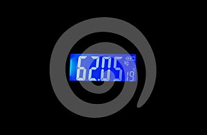 Display of a digital weight machine indicates the weight in kilograms and temperature in degree Celsius  with blueish screen.