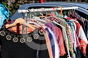 Display of fast fashion women dresses and jackets on rack photo
