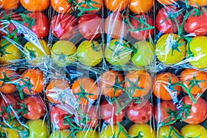 Display of fresh plastic wrapped cherry tomatoes