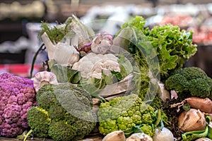 Display of fresh ripe organic broccoli, salad with greens and vegetables in cotton bag at the weekend farmer`s market