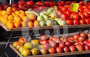 Display of fresh ripe tomatoes at a local farmer`s market