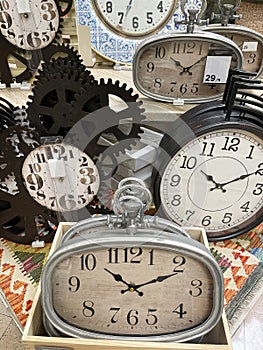 A display with a group of vintage watches, concept of time passing by, antique watches imitation, wall clock