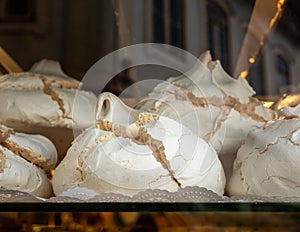 Large portuguese meringues known as Suspiros in bakery photo