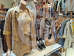 Display of latest woman suit on the fashion store with shoes and bag