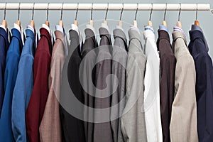 Display of man suits in a closet photo