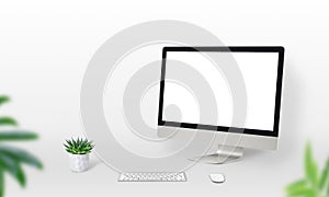 Display mockup on work desk with plants, keyboard and mouse beside