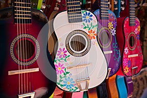 Display of ornate, small Mexican made guitars