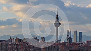 Display of the Piruli TV communications tower captured against a cloudy sky with cityscape of Madrid photo