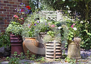 Display of reused chimney pots and pots in bloom photo