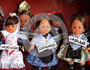 Display of small dolls in regional costume labelled with region in shop, Madrid, Spain