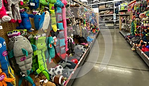 A display of various brands of colorful dog toys for sale at a Petsmart Superstore