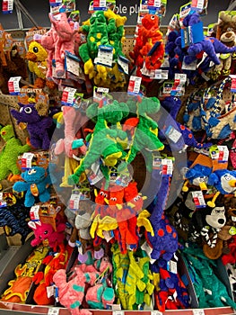 A display of various brands of colorful dog toys for sale at a Petsmart Superstore