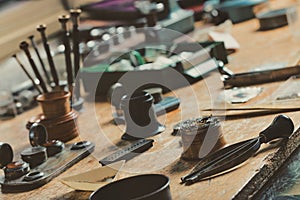 Display of a vintage watchmakers workbench with hand tools