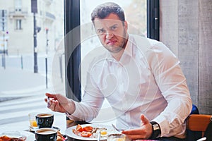 Displeased angry unhappy customer in restaurant photo
