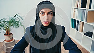 displeased arabian businesswoman in hijab looking photo