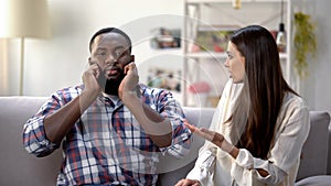 Displeased black man ignoring conversation with girlfriend, disagreement problem