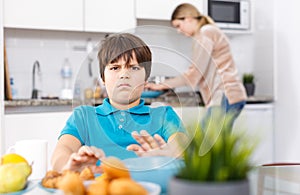 Displeased boy refusing to eat