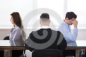 Judge Sitting With Displeased Couple photo