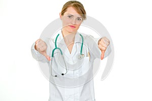 Displeased doctor woman showing thumbs down