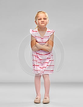 Displeased little girl with crossed arms pouting