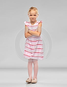 Displeased little girl with crossed arms pouting