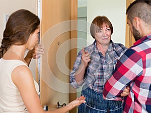 Displeased neighbours arguing in the doorway