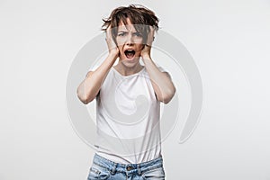 Displeased shocked woman posing isolated over white wall background screaming