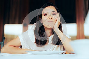 Displeased Woman Waiting Alone in a Restaurant